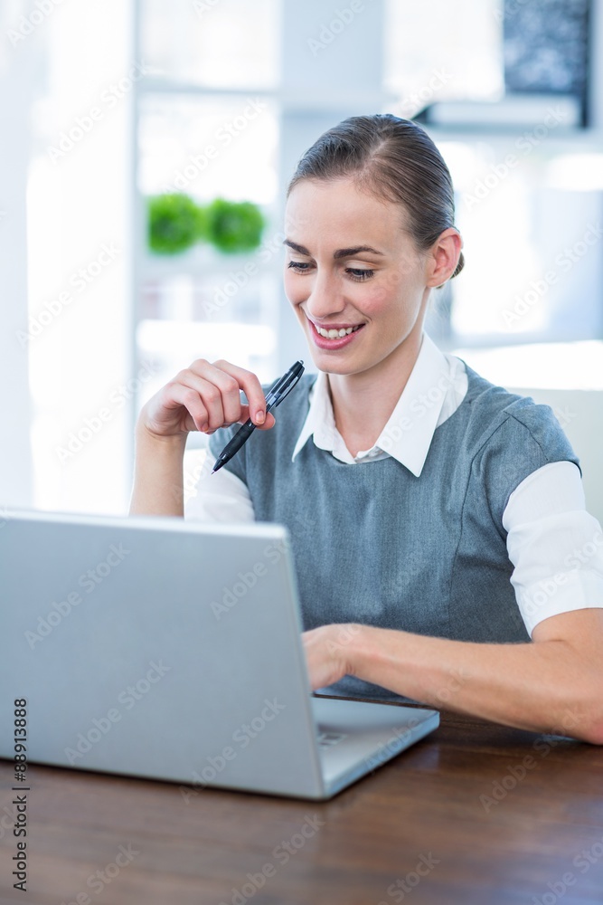 Happy businesswoman working on laptop computer Happy businesswoman working on laptop computer