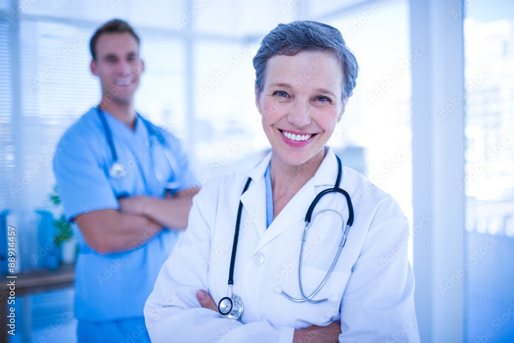 Smiling colleagues doctors looking at the camera Smiling colleagues doctors looking at the camera