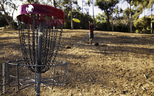 Downhill disk golf throw. 