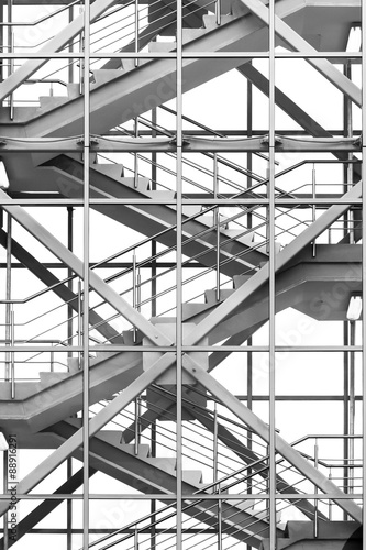 Modern business office stairs with steel handrail in new building with transparent glass walls, architectural geometric abstraction in monochrome