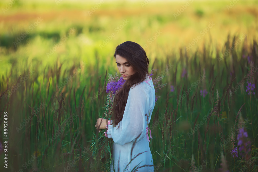 Girl is looking charming look, long shiny hair in lavender field Girl is looking charming look, long shiny hair in lavender field