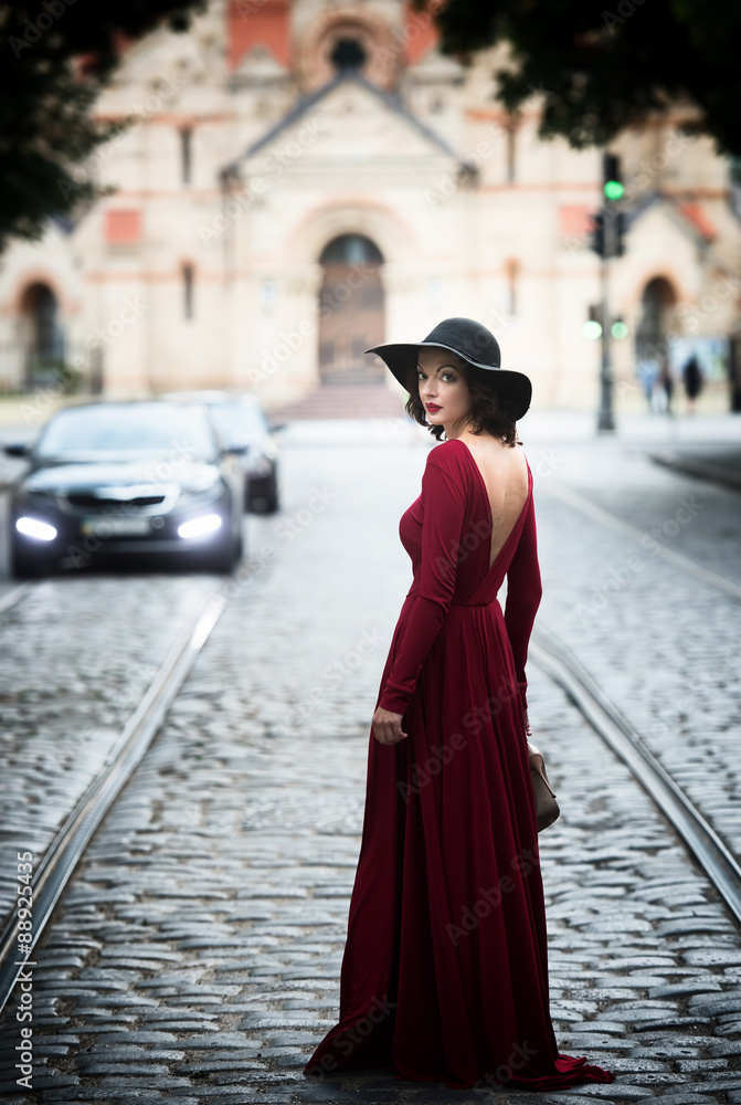 Woman in the long red dress looking back Woman in the long red dress looking back