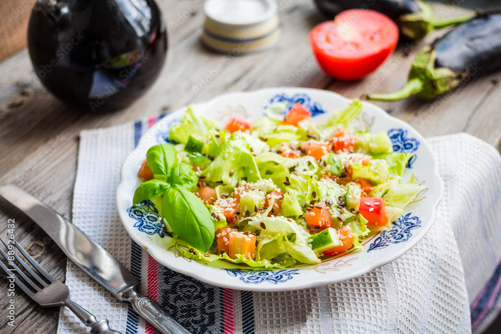 green vegetable salad with tomato, eggplant, sesame seeds and fl green vegetable salad with tomato, eggplant, sesame seeds and fl