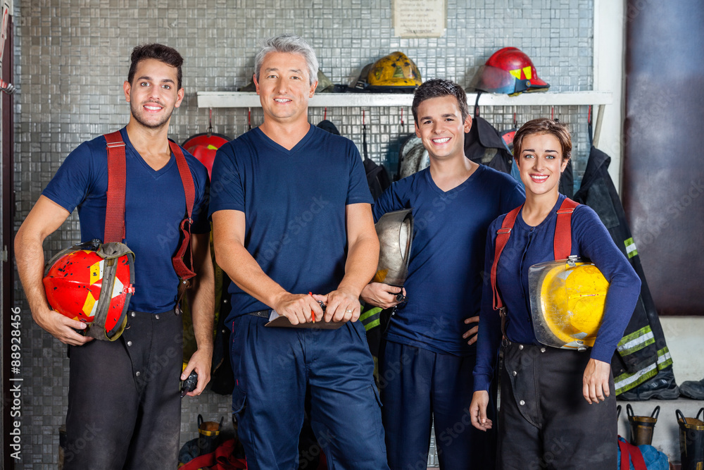 Fototapeta premium Confident Firefighters Standing At Fire Station