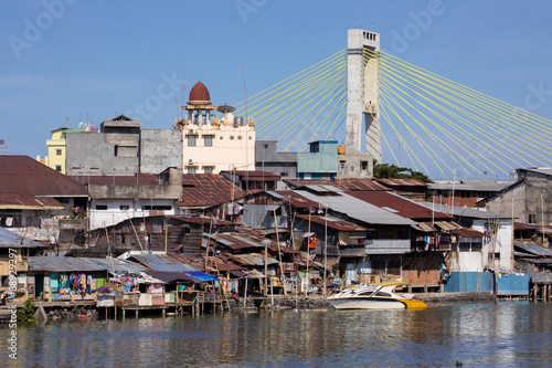 Boats in the estuary to the sea, Manado, Sulawesi, Indonesia photo