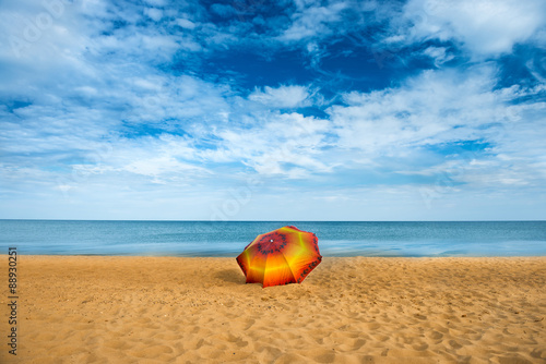 Umbrella on golden sand beach