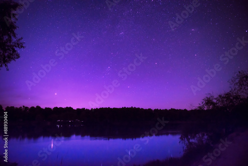 Beautiful night sky with many stars on a lake