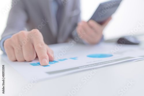 Businessman analyzing investment charts with computer. Accountin