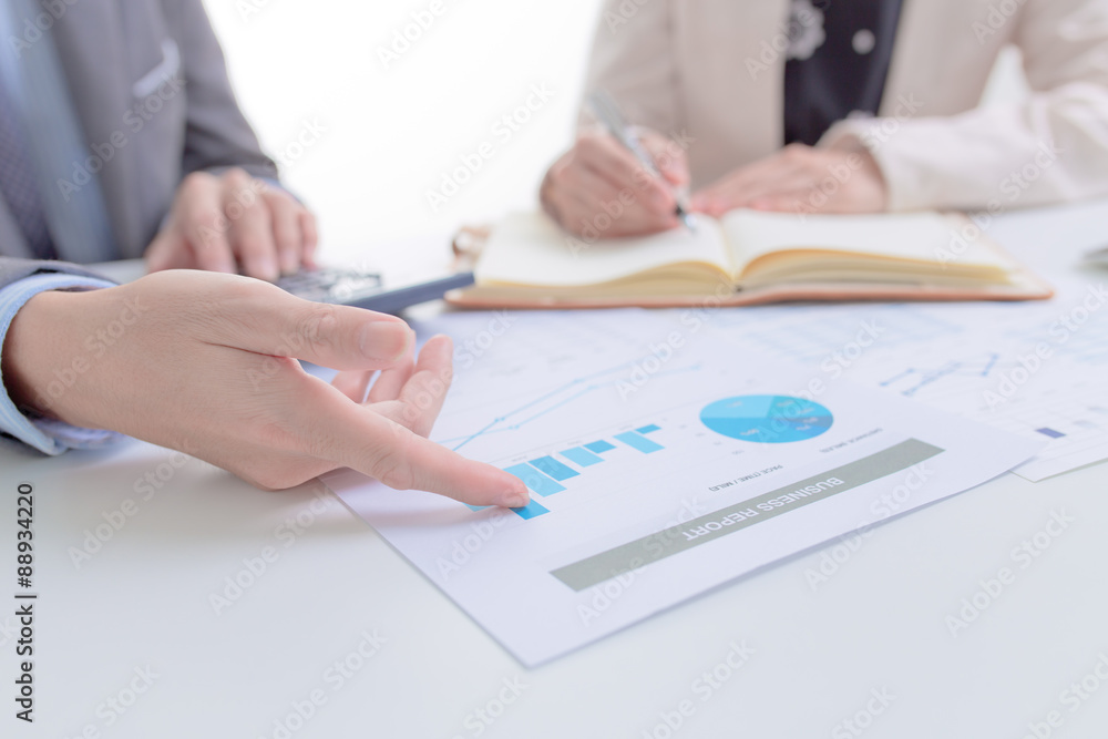 Business people discussing the charts and graphs showing the res Business people discussing the charts and graphs showing the res