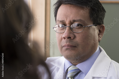 Hispanic male doctor with patient