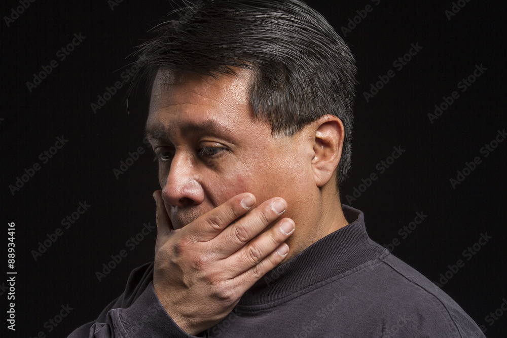 Studio portrait of a stressed Hispanic male