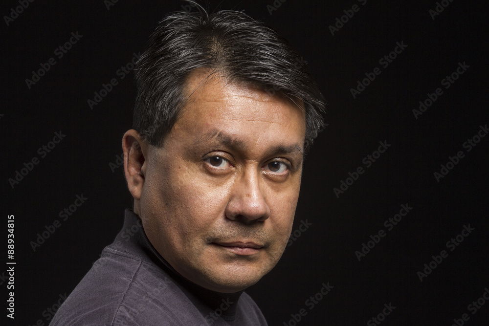 Fototapeta premium Studio portrait of a serious Hispanic male