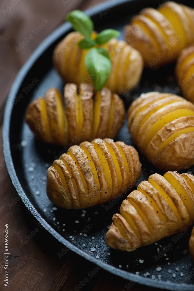 Potatoes cut into slices almost right through and then baked Potatoes cut into slices almost right through and then baked