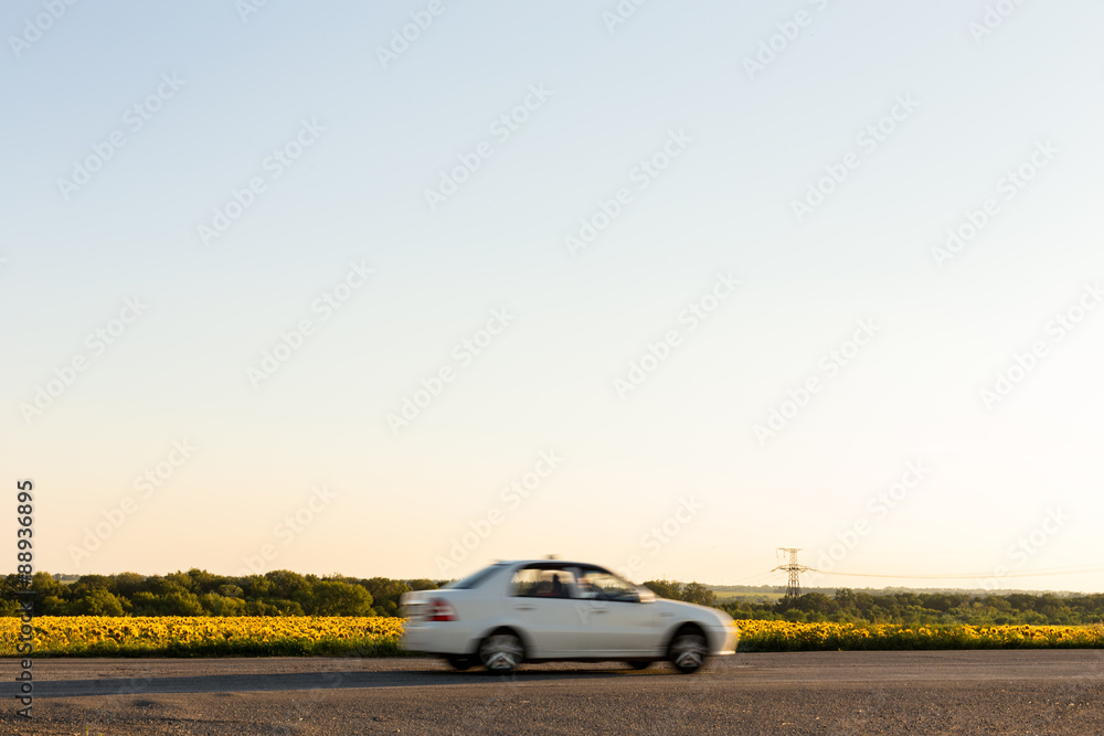 Fototapeta premium Blurred car next to field