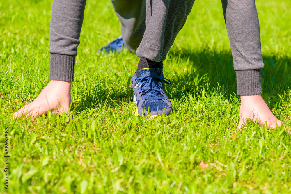 Athlete ready to run on the green lawn Athlete ready to run on the green lawn