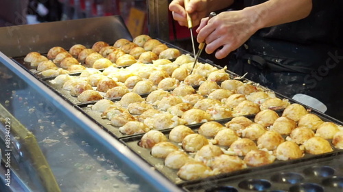 Cooking takoyaki Japanese octopus flour ball. Traditional Japan snack cuisine