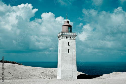 Lighthouse, sand and sea