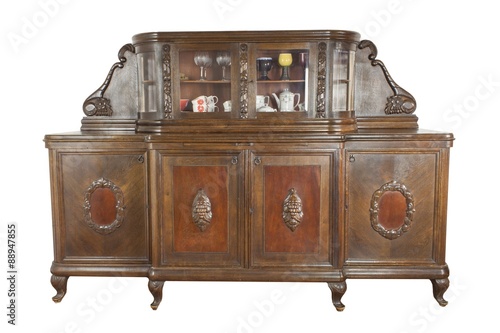 Vintage wooden art Nouveau cabinet isolated on white background. Historical cabinet with glass showcase. Insight into the history of furniture manufacturing.