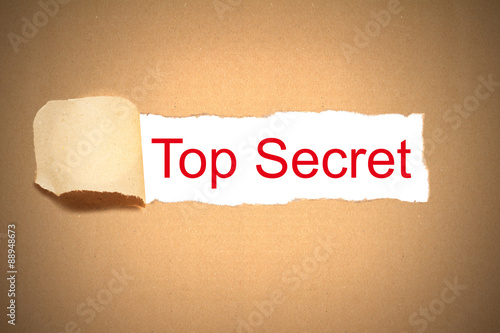 brown paper torn to reveal top secret