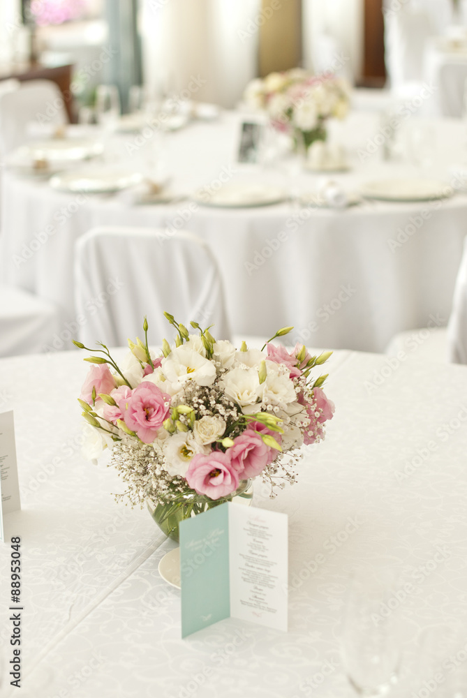 Menu card with beautiful flowers on table in wedding day Menu card with beautiful flowers on table in wedding day
