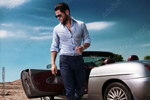 Handsome man near the car. Luxury life.