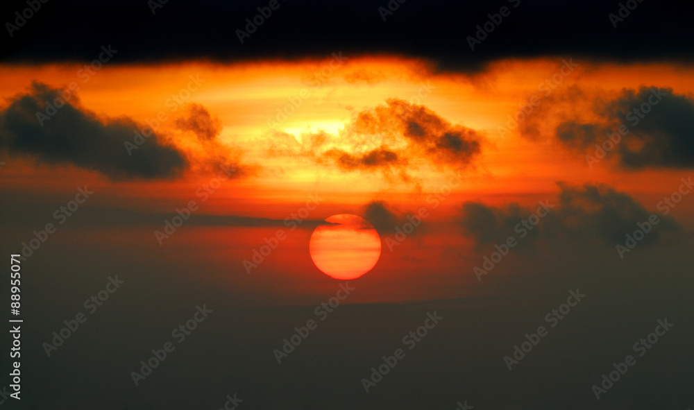 red sun with dark clouds