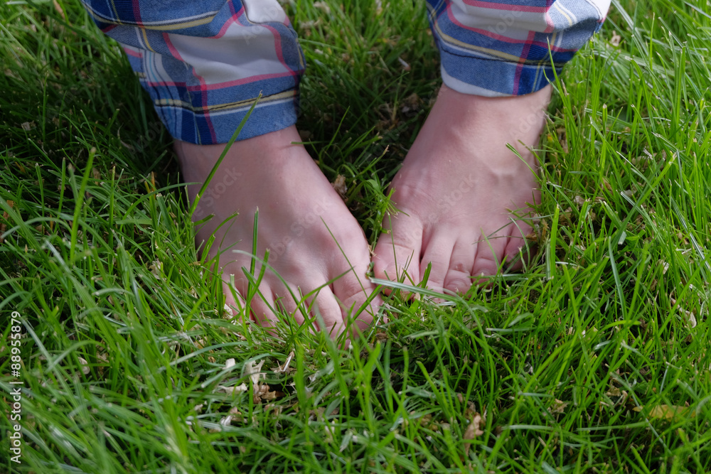 Feet in grass. Barefoot summer pleasure