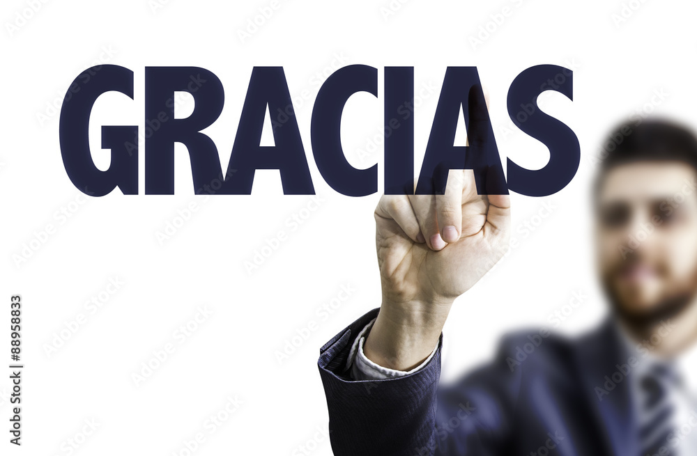 Business man pointing the text: Thank You (in Spanish) Business man pointing the text: Thank You (in Spanish)