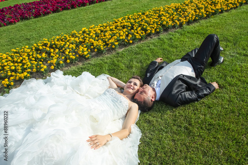 Married couple lying on lawn
