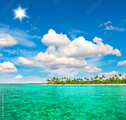 Fototapeta Naklejka Na Ścianę i Meble -  Tropical island beach with palm trees and blue sky