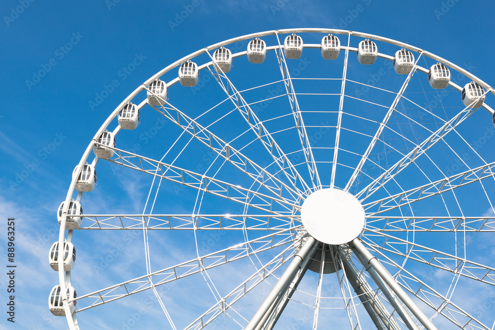 white ferris wheel against blue sky background white ferris wheel against blue sky background