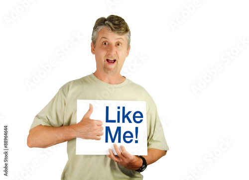 Man holding a Like Me sign as he gives a thumbs up