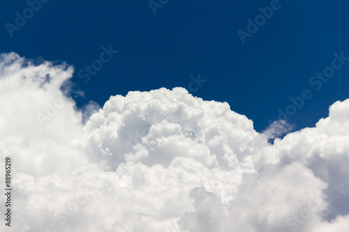 beautiful big puffy white clouds in light cheerful light blue sky with fresh feeling
