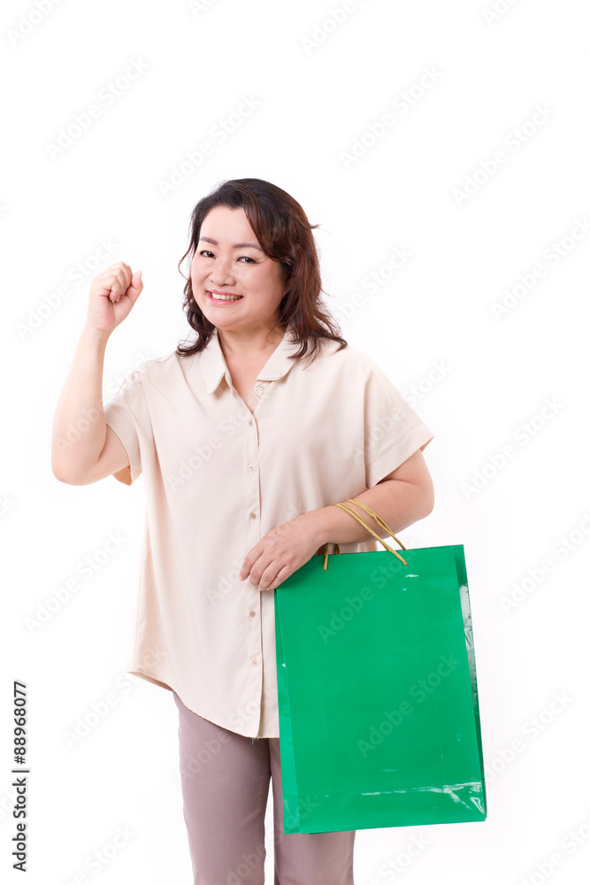 tough, happy middle aged asian woman with shopping bag tough, happy middle aged asian woman with shopping bag