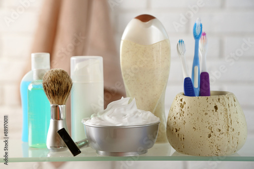 Male luxury shaving kit on shelf, on bricks wall background