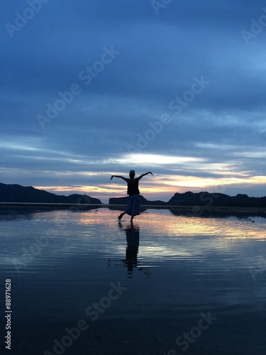 silhouette of girl doing yoga in the twilight time