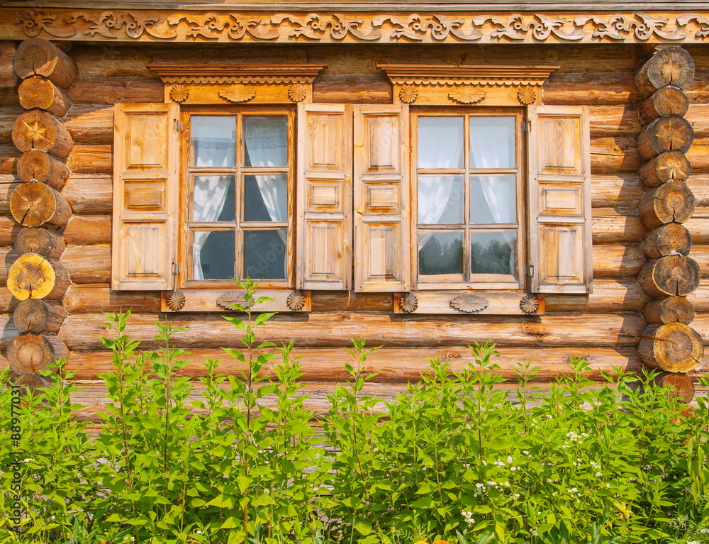 Russian timbered log hut decorated with wood carvings