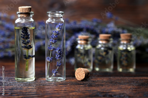 Lavender oil in a glass bottle on a wodden table