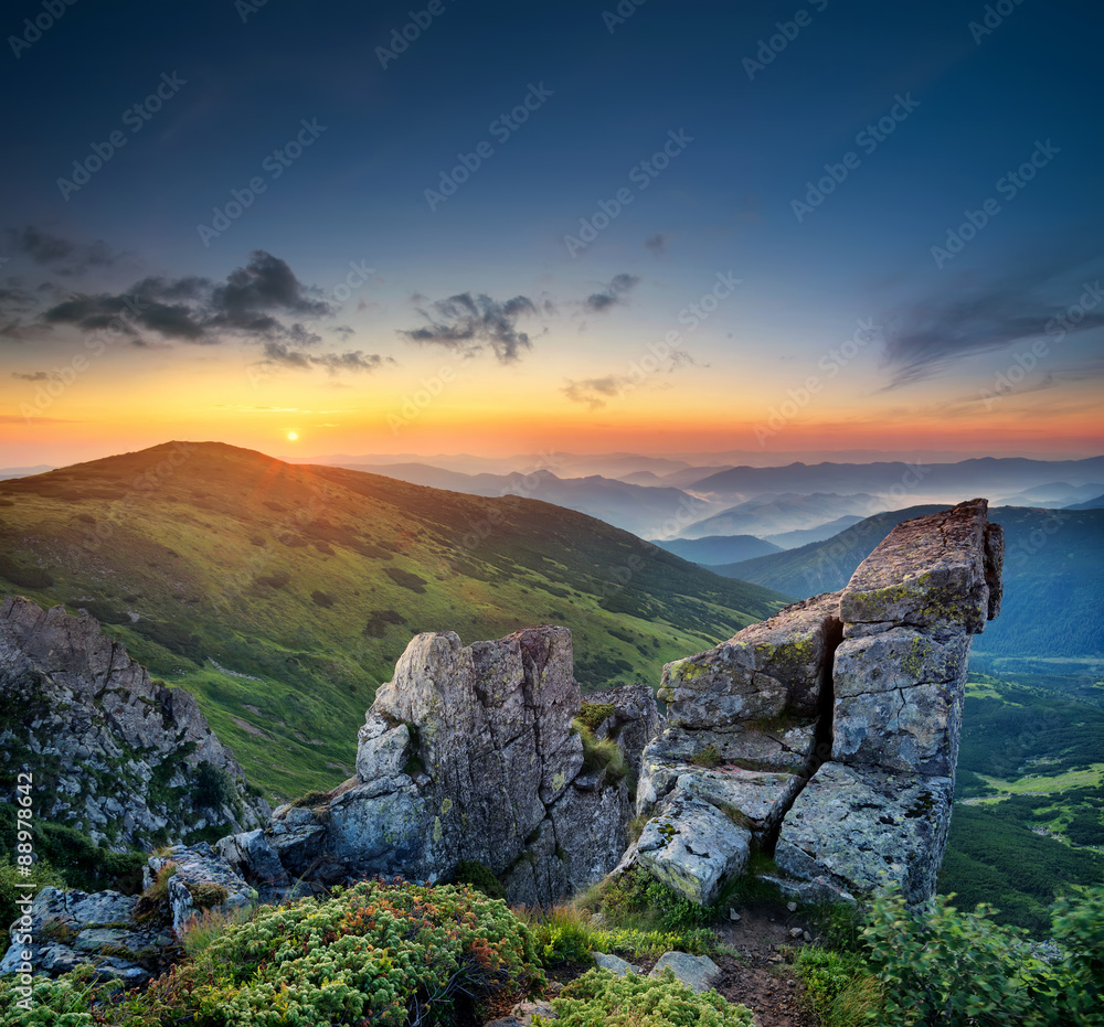 High rocks in mountain valley during sunrise. Natural summer landscape