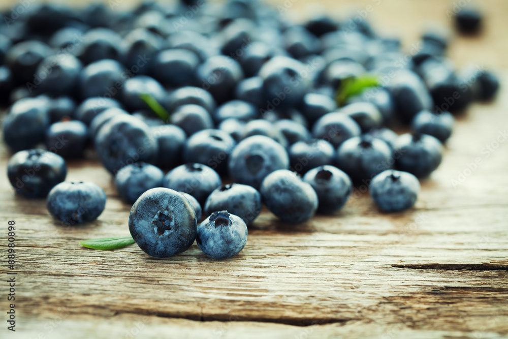 Blueberry, great bilberry or bog whortleberry on wooden rustic board Blueberry, great bilberry or bog whortleberry on wooden rustic board