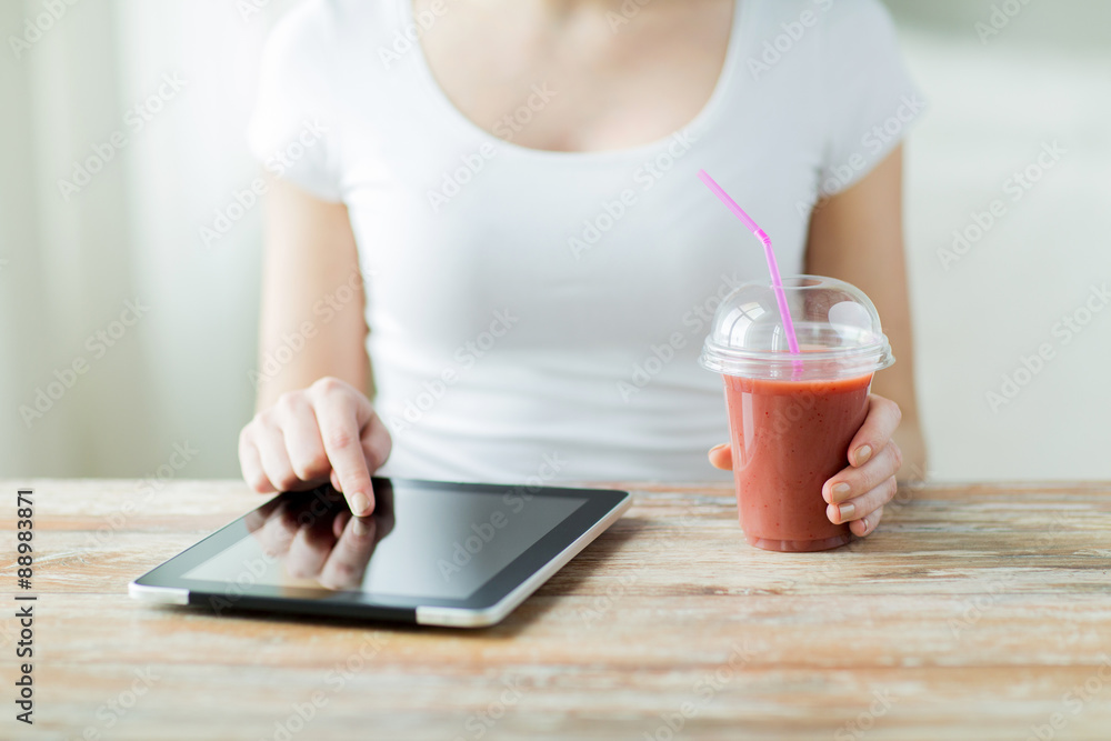 close up of woman with tablet pc and smoothie close up of woman with tablet pc and smoothie