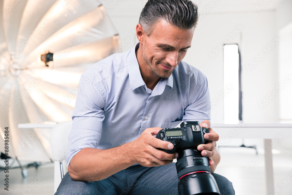 Happy photographer using camera Happy photographer using camera