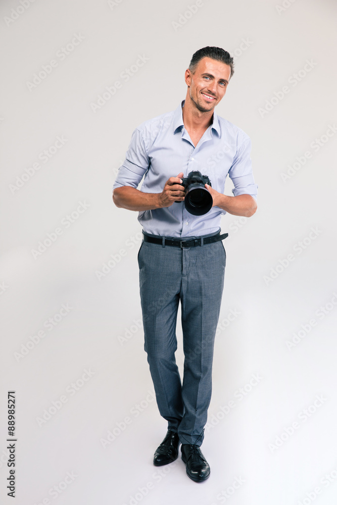 Happy young man holding camera Happy young man holding camera