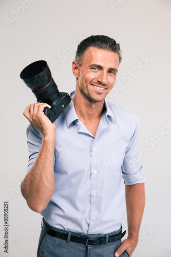 Smiling handsome man holding camera