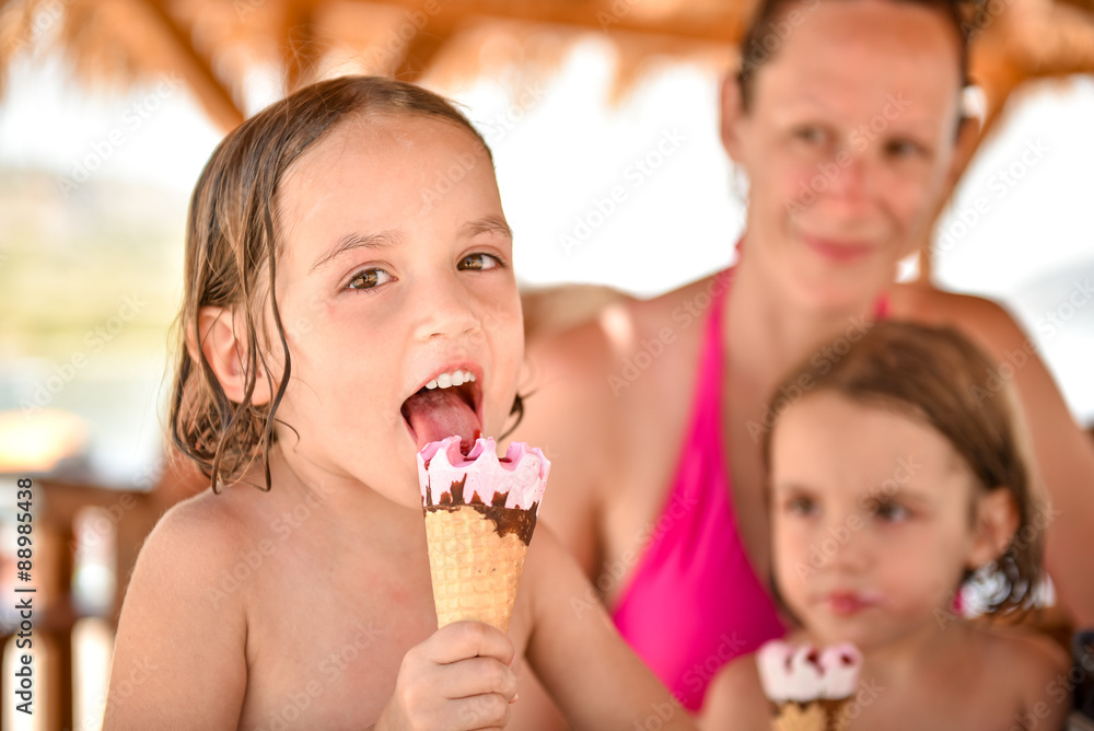 Happy family with little girl smiling and eating ice cream