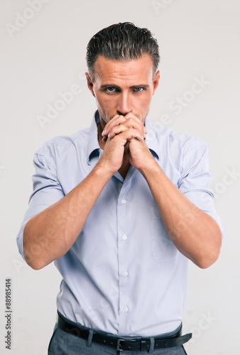 Portrait of a handsome businessman praying