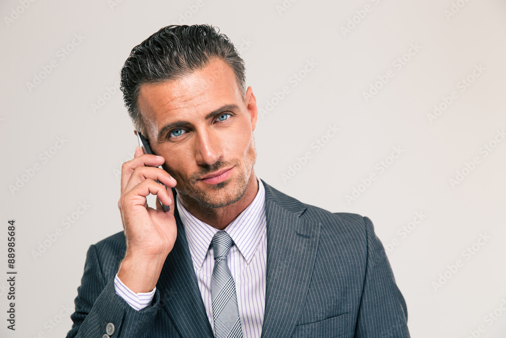 Serious businessman talking on the phone Serious businessman talking on the phone