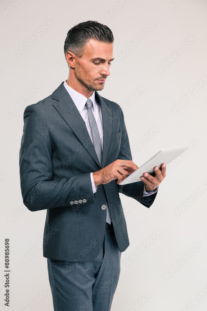 Handsome businessman using tablet computer Handsome businessman using tablet computer