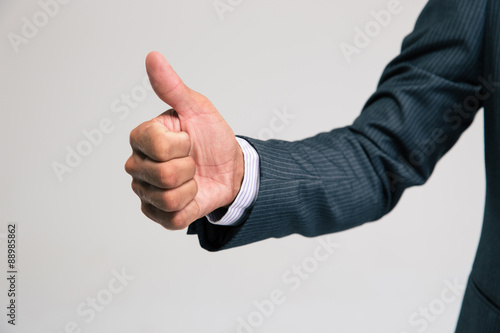 Businessman`s hand showing thumb up photo