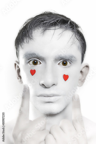 man with white makeup and red hearts on face